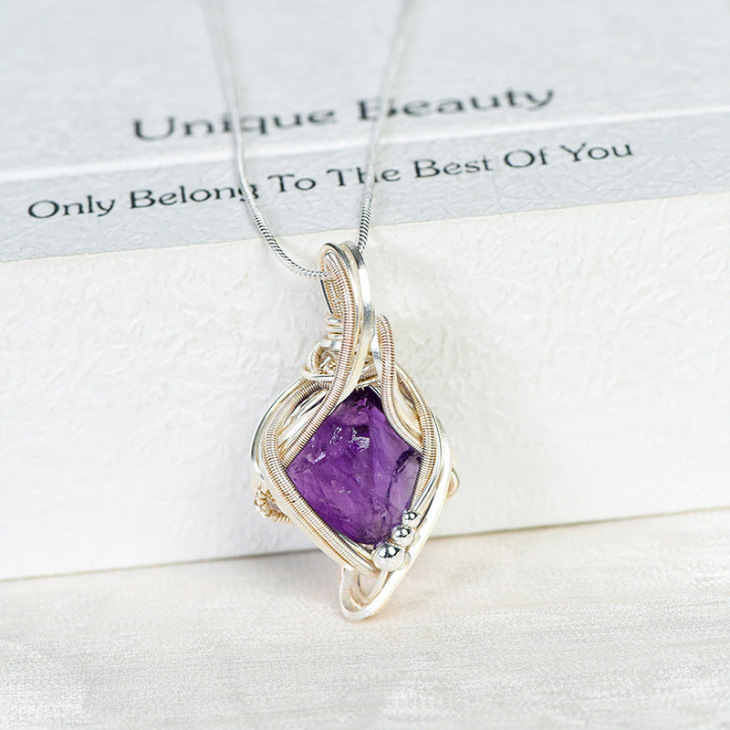 Rose Quartz pendant showing detailed silver-tone wire wrapping around the irregular crystal stone