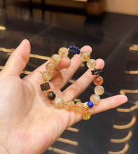 Detailed bracelet view showing Black Gold Super Seven, Lapis Lazuli, Agarwood accents and handmade decorative elements