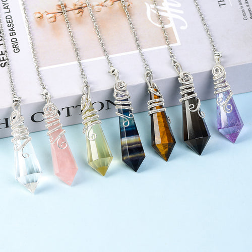 Dark faceted 12-facet crystal pendulum with silver-tone wire wrapping and link chain on a white background