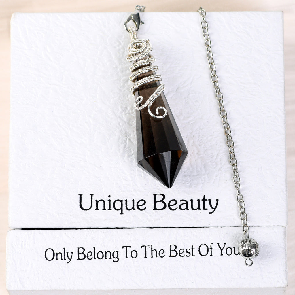 Close-up of decorative silver-tone wire wrapping around the upper section of a faceted crystal pendulum