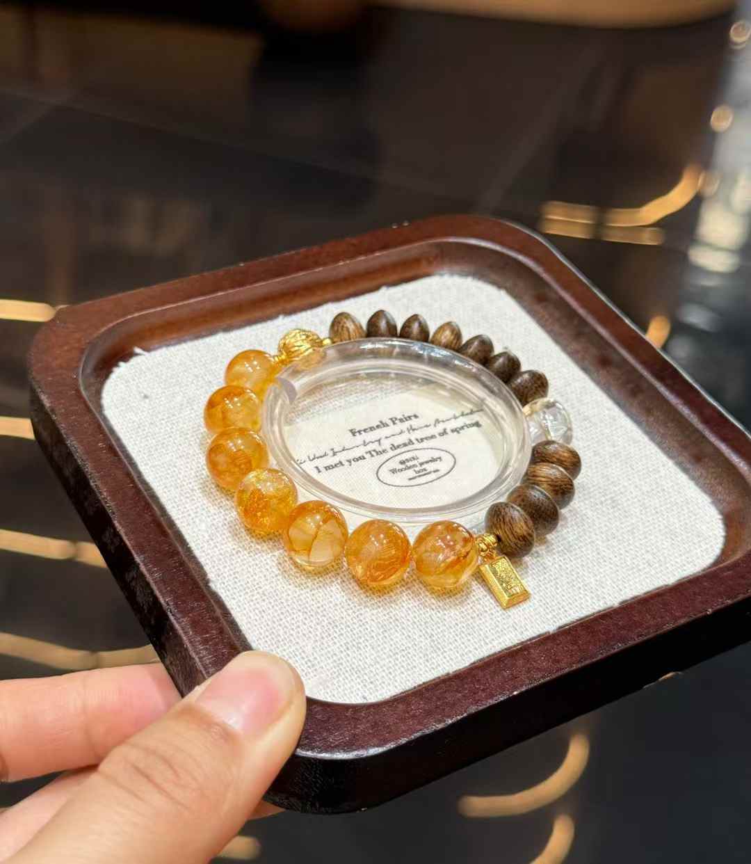 Full view of the Yellow Hematoid Quartz bracelet showing golden round beads, oval Agarwood beads and Clear Quartz accents