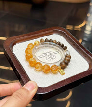 Full view of the Yellow Hematoid Quartz bracelet showing golden round beads, oval Agarwood beads and Clear Quartz accents