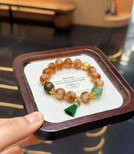 Full view of Yellow Tower Crystal beaded bracelet with Green Strawberry Quartz focal bead and handmade tassel