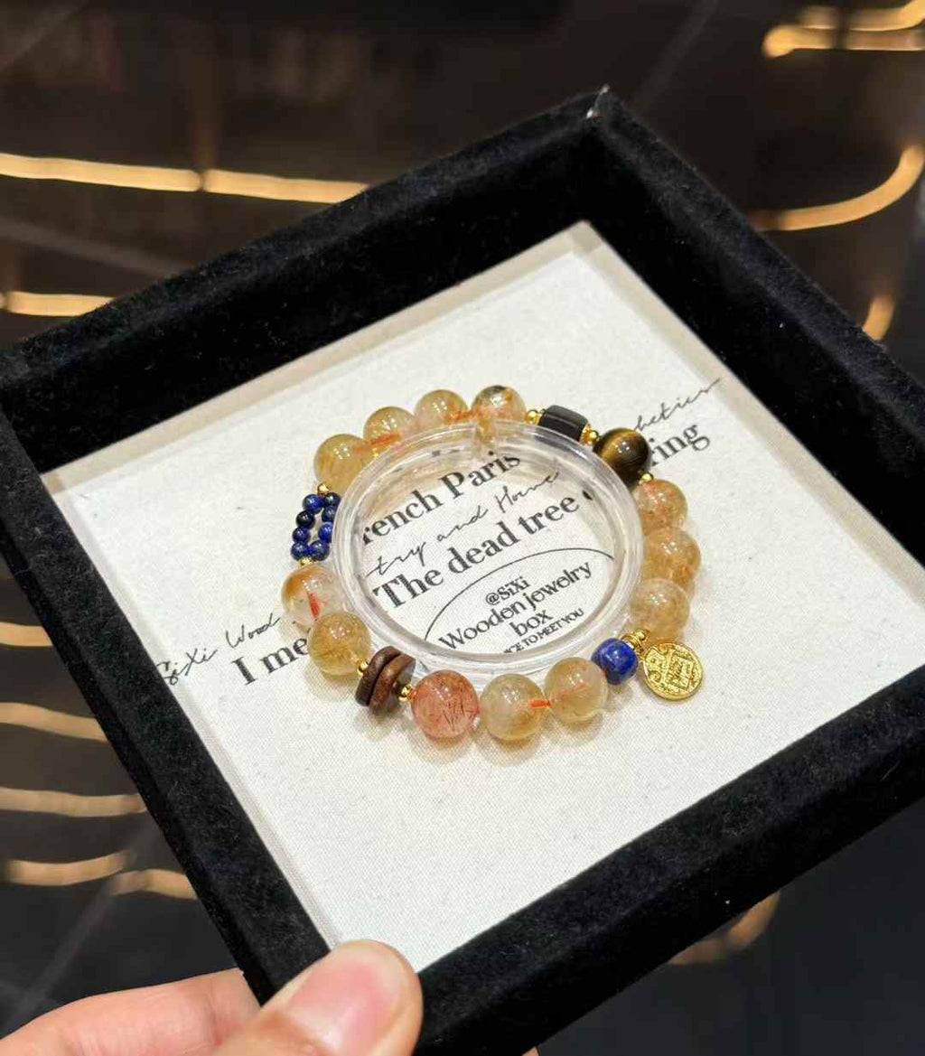 Full view of the mixed gemstone bracelet showing Yellow Tower Quartz beads, dark wood accents, blue Lapis Lazuli and copper details