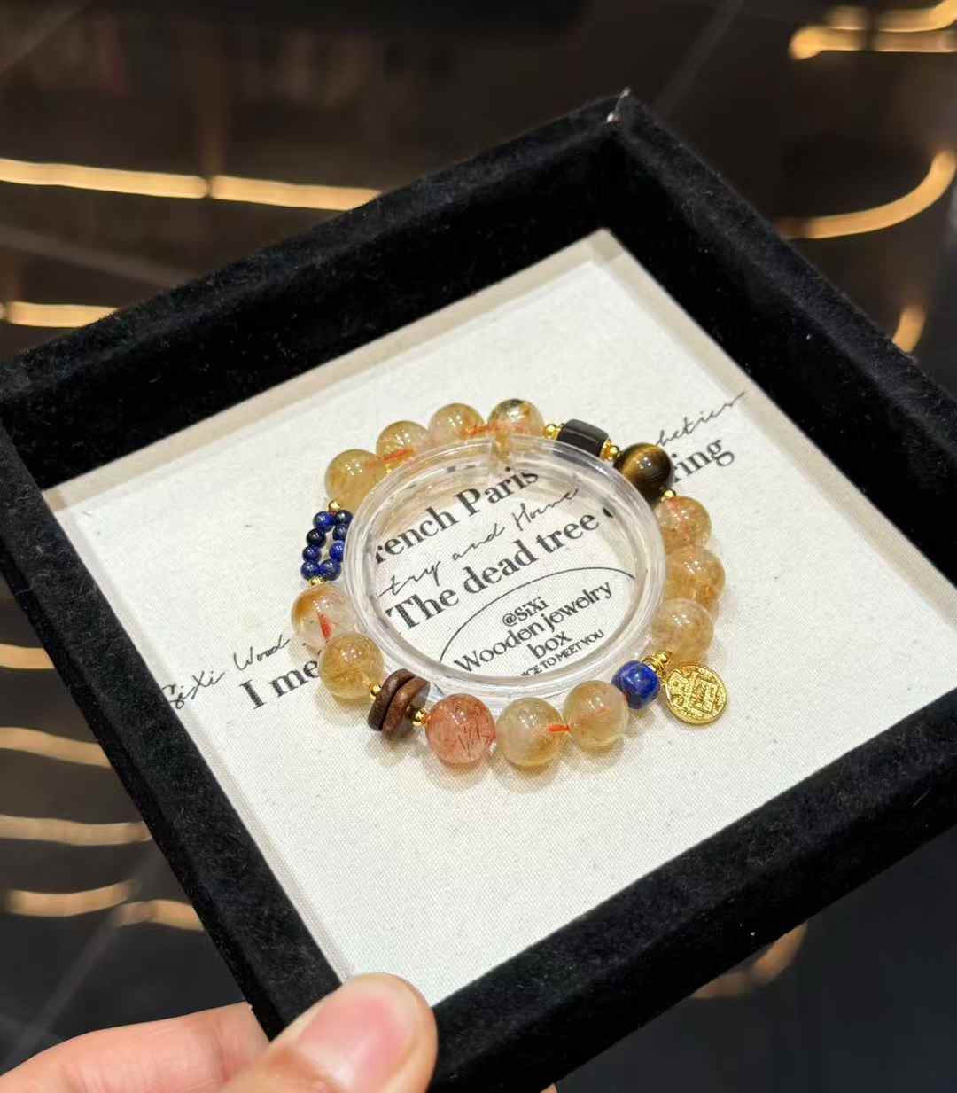 Full view of the mixed gemstone bracelet showing Yellow Tower Quartz beads, dark wood accents, blue Lapis Lazuli and copper details