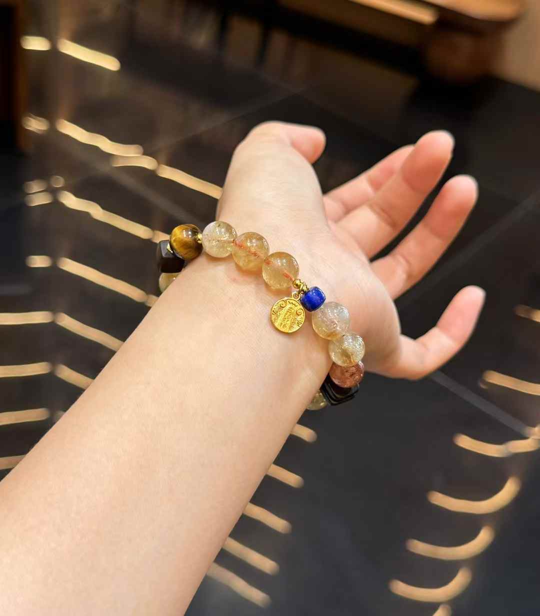 Yellow Tower Quartz mixed gemstone bracelet worn on the wrist with Lapis Lazuli and copper charm details