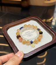 Close view of polished Yellow Tower Quartz beads with warm golden tones and mixed gemstone accent beads